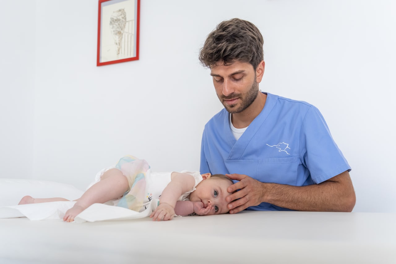 Giuseppe Feroleto durante un trattamento osteopatico delicato a un neonato